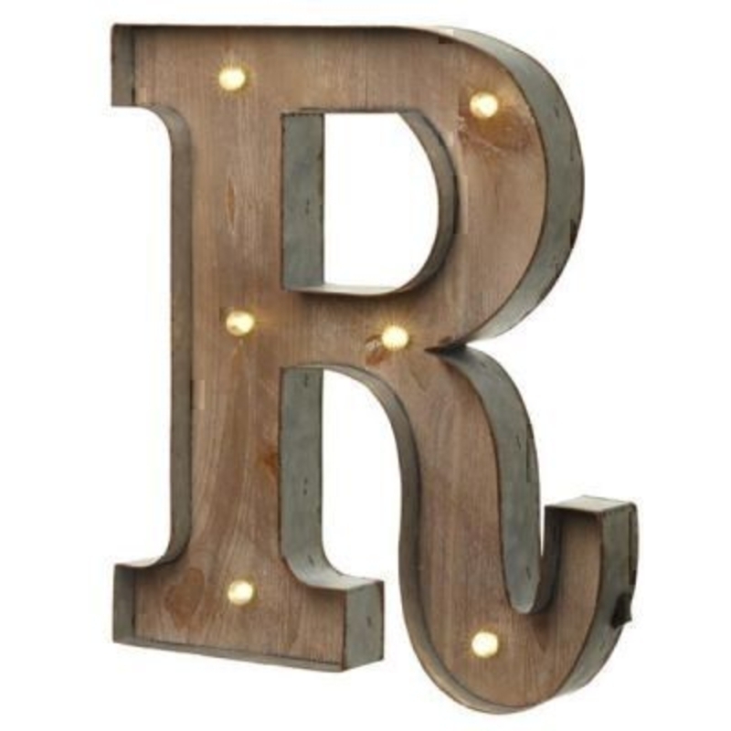 This R Sign With LED Lights by Heaven Sends could be paired with other letters to create a bespoke initial sign for a couple and or to be displayed on its own. Large in size this R sign has got LED lights and a switch on the side to turn it on. Made from wood and metal. Size: 35x5x41cm